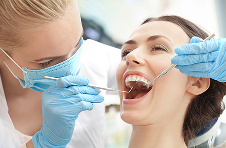 A dental hygienist assisting a patient with a dental procedure.